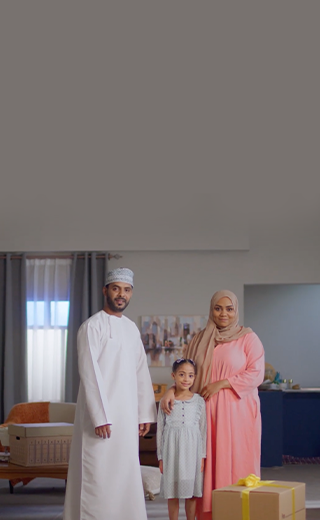 The image shows a family of a parents with a kid in the middle standing together in a living room
